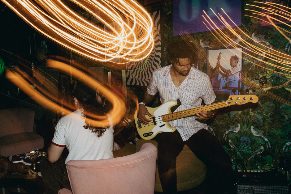 A photograph of a man playing a Fender guitar at the Fender House activation in Austin, Texas.