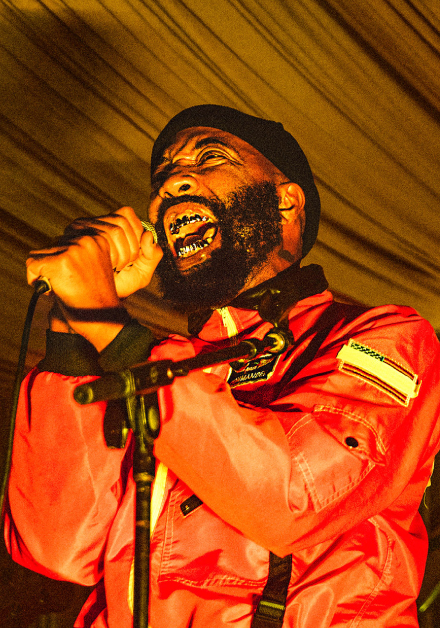 Photograph of a man singing at the Fender House activation