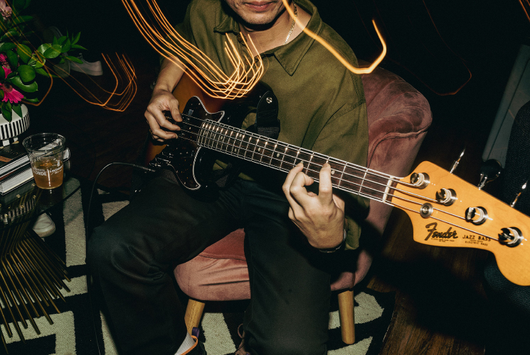 Photograph of a man playing guitar at the Fender House activation