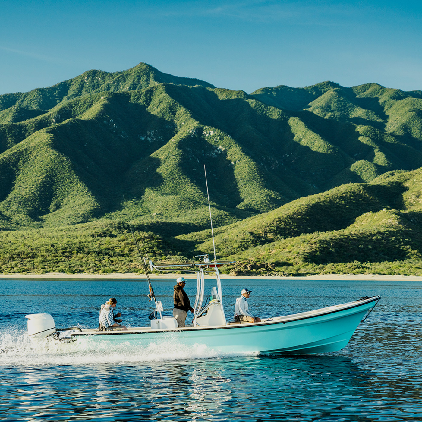 Photograph of a boat in water with mountains for Costa