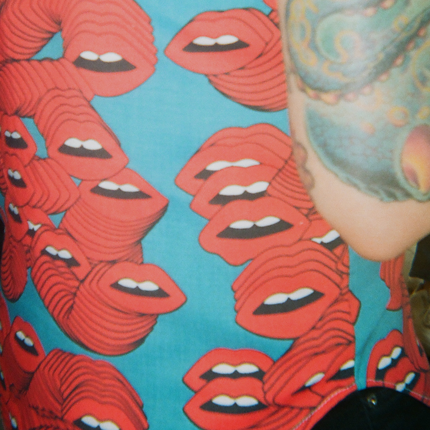 Close-up photo of someone's shirt and tattoo