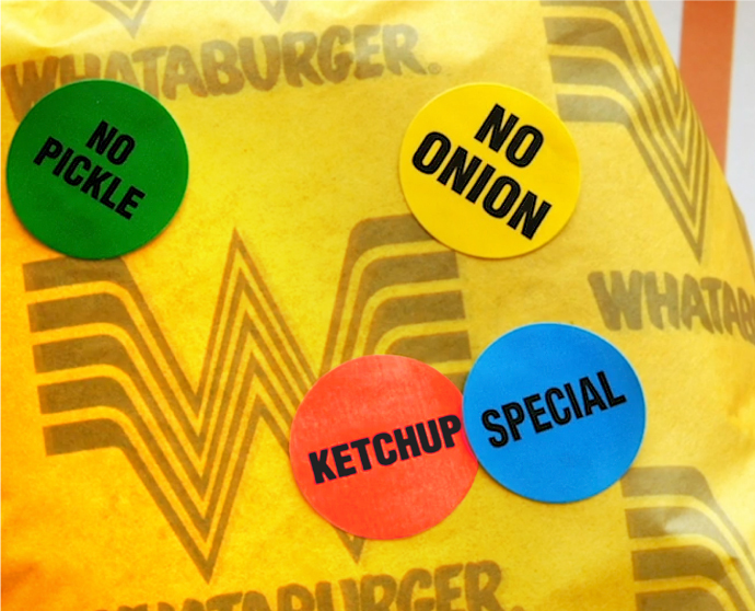 A close up photograph of the sticker designs on a burger wrapper for Whataburger