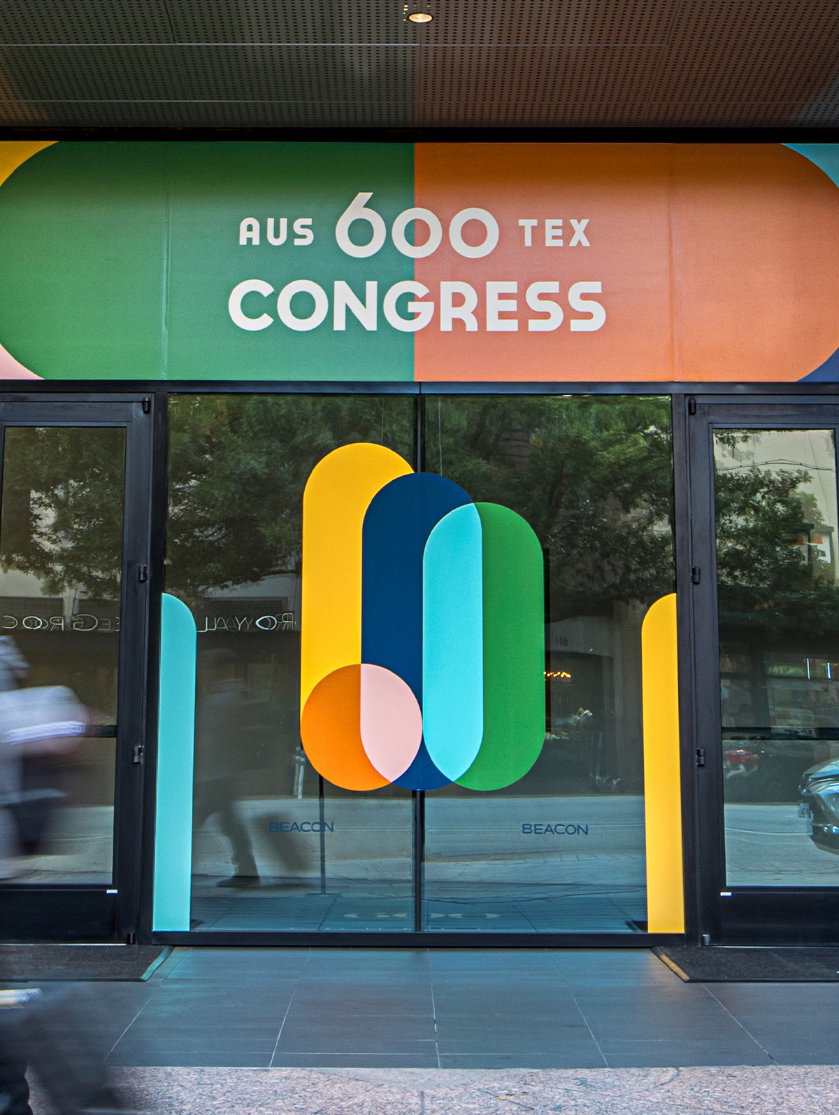 Close-up photo of window cling designs on the 600 Congress building including the branding