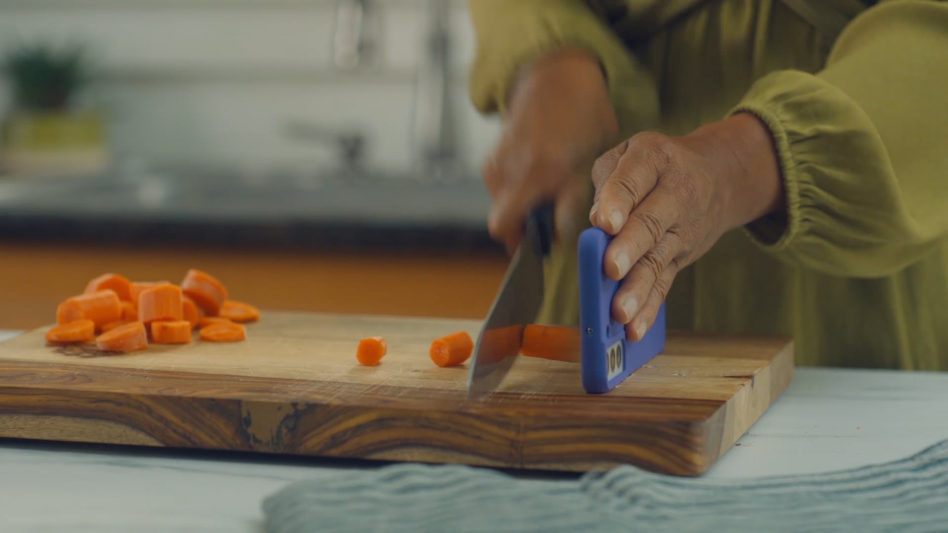 Behind the scenes footage of the prop master testing out the carrot chopping prop from the Instacart film It's All In Your Phone