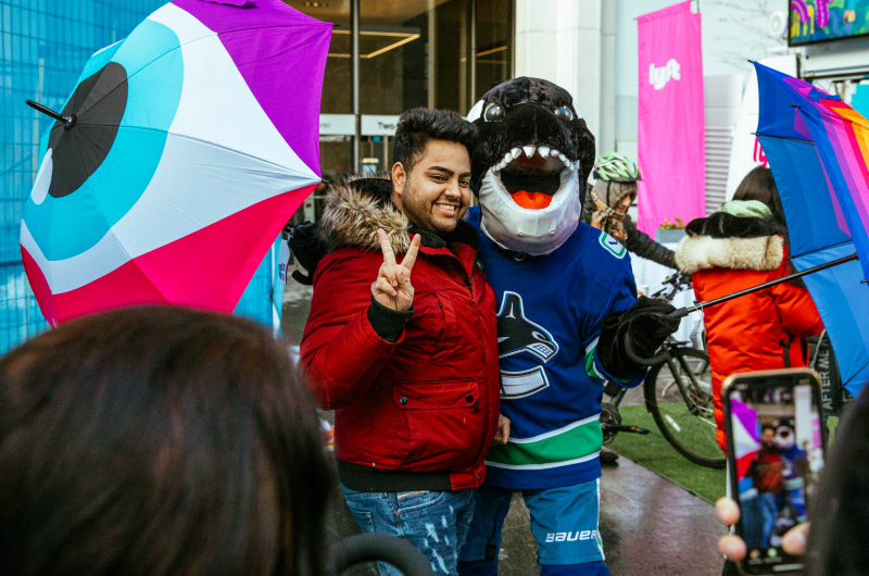 A photo of the Lyft Vancouver activation with people posing for photos with the custom umbrella designs