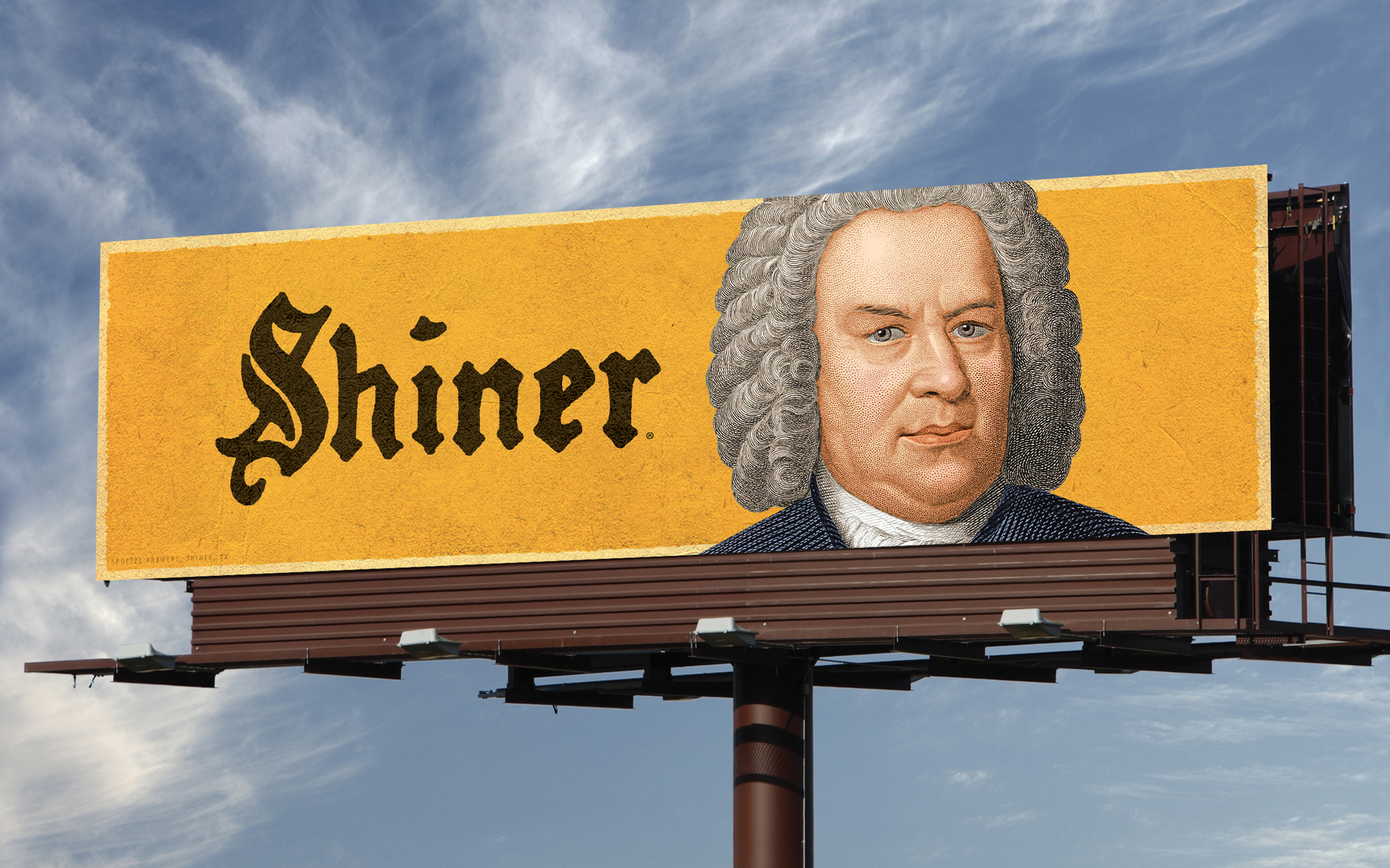 A billboard for Shiner that has the Shiner logo and illustrated depiction of Johann Sebastian Bach