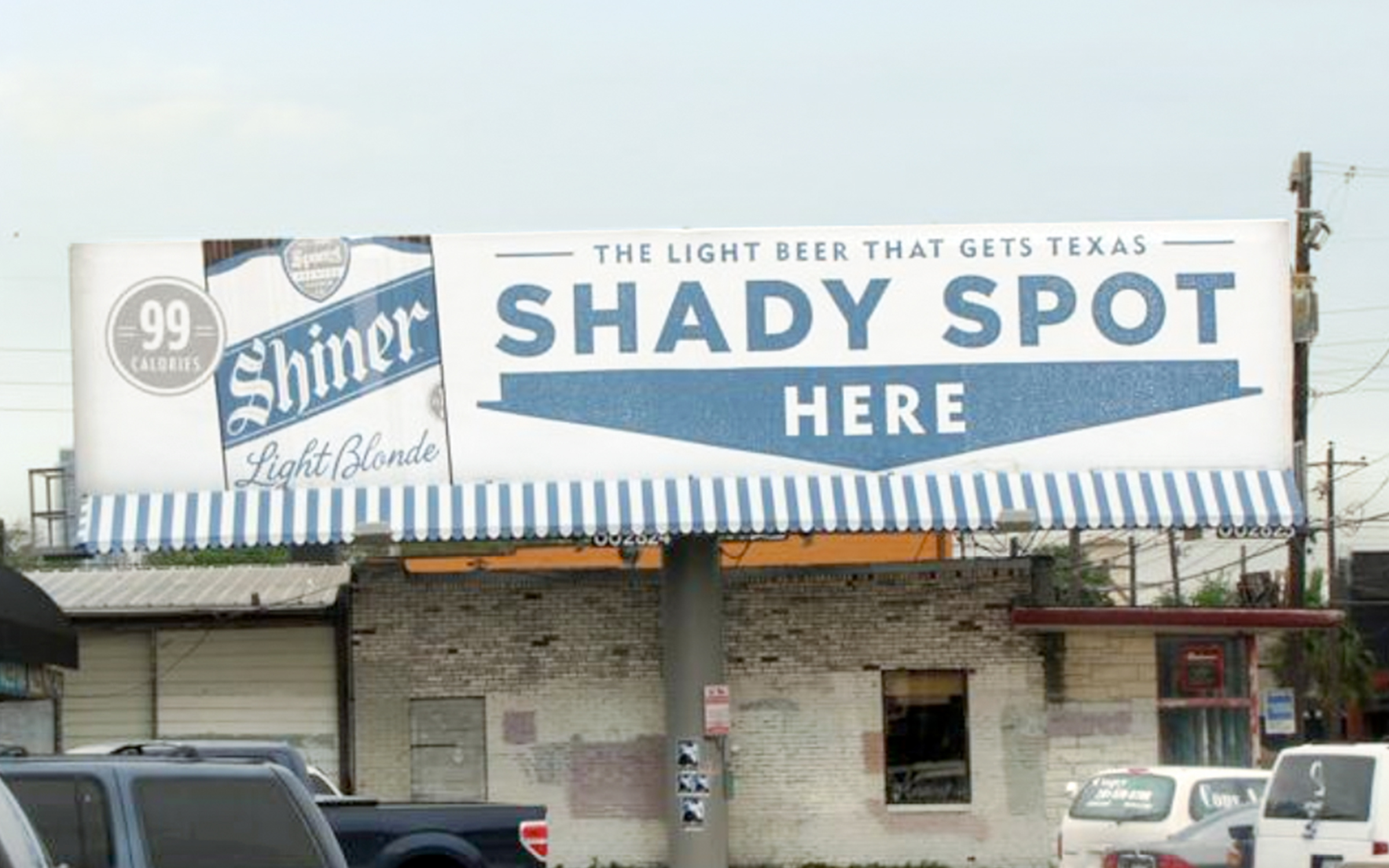 A billboard design for Shiner Light Blond that includes an an awning. It reads "The light beer that gets Texas" including an arrow that says "Shady spot here"