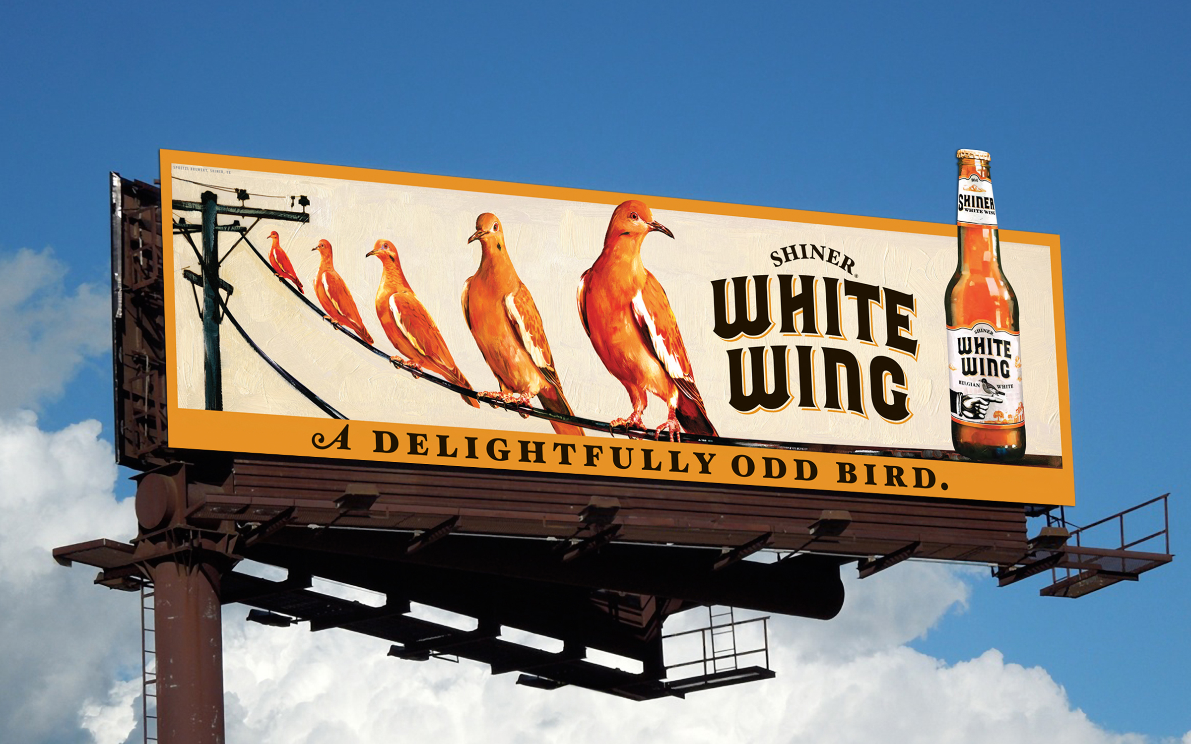 A photo of a billboard for Shiner White Wing that reads "A delightfully odd bird"