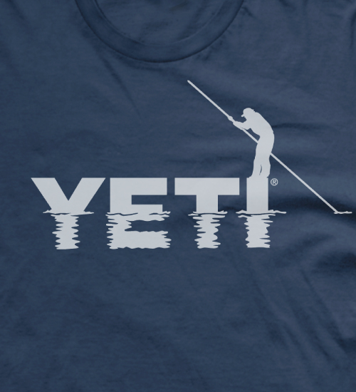 YETI t-shrit design of a fisherman standing on the logo as the water ripples